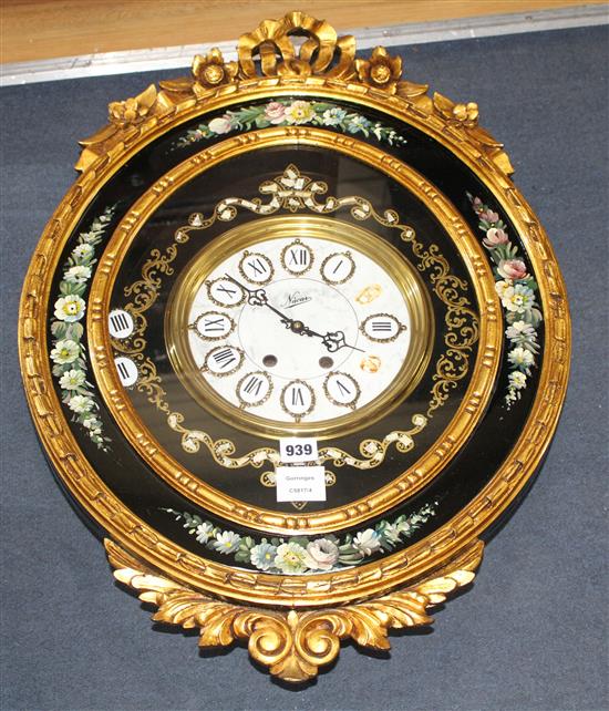 An ornate gold and floral painted electric wall clock, W.48cm H.68cm